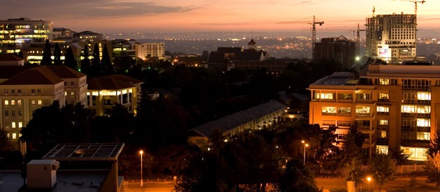 Dusk skyline of Alberton showcasing the city lights and construction cranes indicating growth and development.